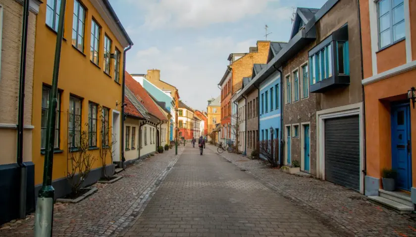 En kullerstensgata i Skåne med färgglada hus. Perfekt för gratis aktiviteter som en promenad eller cykeltur.